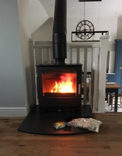  Mendip Woodland stove with slate hearth and premier twist and lock twin wall flue system coming off top