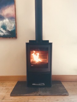 Di Lusso R5 multi Fuel stove with slate hearth and premier twist and lock twin wall flue system coming off top